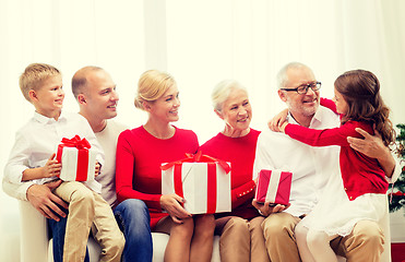 Image showing smiling family with gifts at home