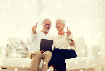 Image showing happy senior couple with tablet pc at home