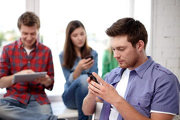 Image showing group of students with smartphone at school