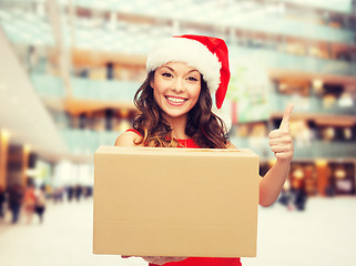 Image showing smiling woman in santa helper hat with parcel box