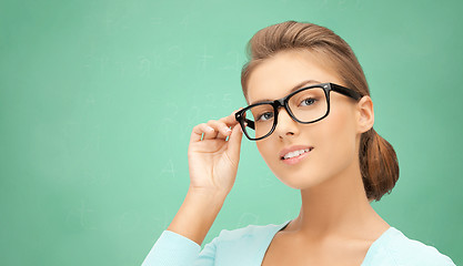 Image showing happy teenage student girl or woman in eyeglasses