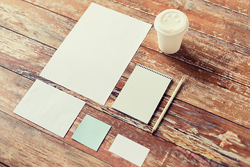 Image showing close up of notebook, coffee cup and papers