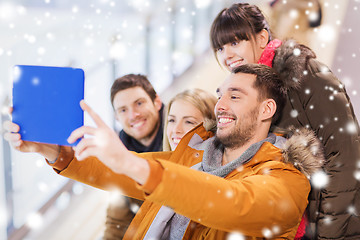 Image showing happy friends with tablet pc on skating rink