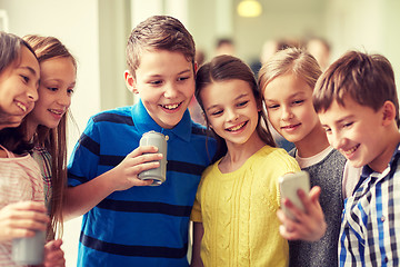 Image showing group of school kids with smartphone and soda cans