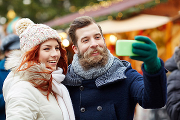 Image showing couple taking selfie with smartphone in old town
