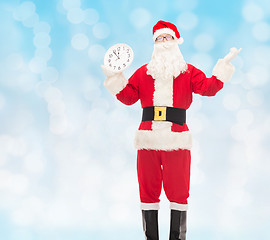 Image showing man in costume of santa claus with clock