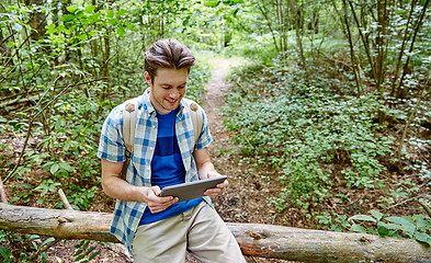 Image showing happy man with backpack and tablet pc in woods