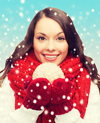 Image showing woman in scarf and mittens with christmas ball