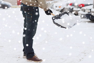 Image showing closeup of man digging snow with shovel near car