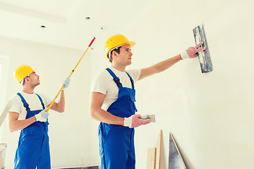 Image showing group of builders with tools indoors