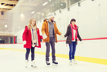 Image showing happy friends on skating rink