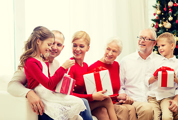 Image showing smiling family with gifts at home