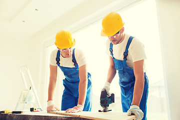 Image showing group of builders with tools indoors