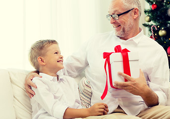 Image showing smiling grandfather and grandson at home