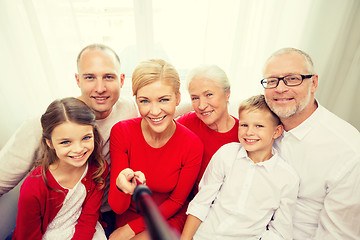 Image showing smiling family taking selfie at home