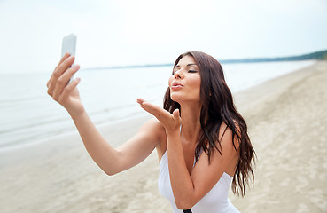 Image showing young woman taking selfie with smartphone