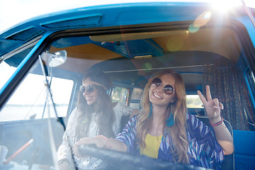 Image showing smiling young hippie women driving minivan car