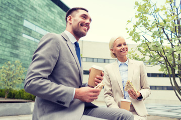 Image showing smiling businessmen with paper cups outdoors