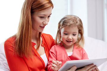 Image showing happy mother and daughter with tablet pc computer