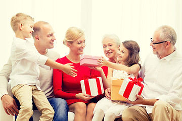 Image showing smiling family with gifts at home