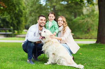 Image showing happy family with labrador retriever dog in park