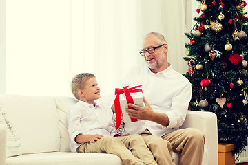 Image showing smiling grandfather and grandson at home