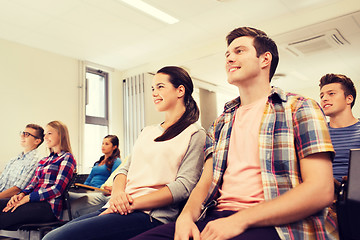 Image showing group of smiling students in lecture hall