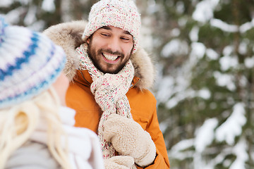 Image showing happy friends or couple in winter forest