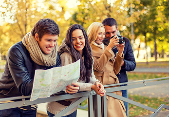 Image showing group of friends with map and camera outdoors