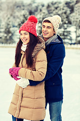 Image showing happy couple ice skating on rink outdoors