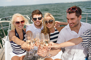 Image showing smiling friends with glasses of champagne on yacht