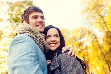 Image showing smiling couple hugging in autumn park