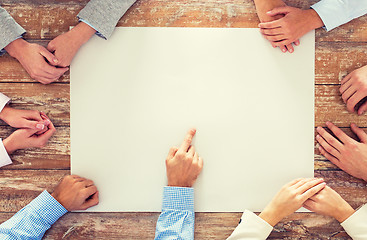 Image showing close up of business team with paper at table