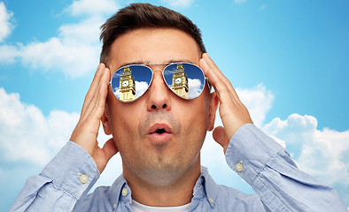Image showing face of man in sunglasses looking at big ben tower