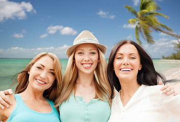 Image showing group of happy young women over summer beach