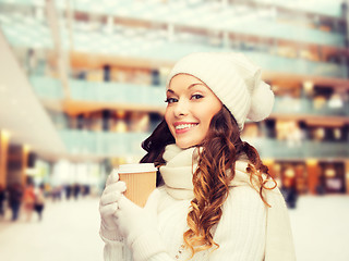 Image showing smiling young woman in winter clothes with cup