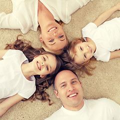 Image showing parents and two girls lying on floor at home