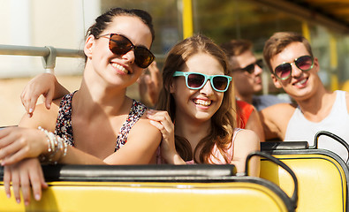 Image showing group of smiling friends traveling by tour bus