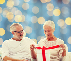 Image showing happy senior couple with gift box