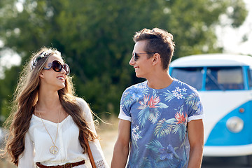 Image showing smiling young hippie couple over minivan car