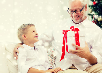 Image showing smiling grandfather and grandson at home