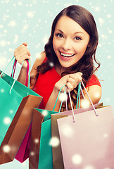 Image showing woman in red dress with shopping bags