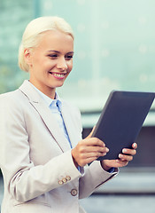 Image showing smiling businesswoman with tablet pc outdoors