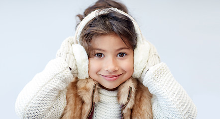 Image showing happy little girl wearing earmuffs