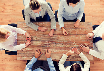 Image showing close up of business team sitting at table