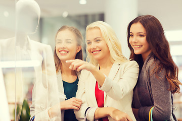 Image showing happy young women with shopping bags in mall