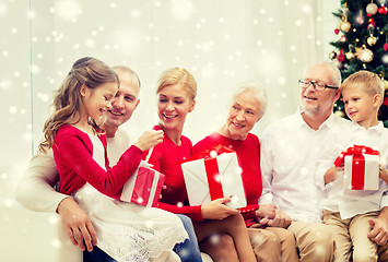 Image showing smiling family with gifts at home