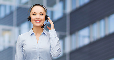 Image showing helpline operator in headset over business center