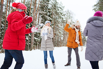 Image showing happy friends playing snowball in winter forest