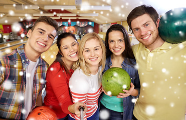 Image showing happy friends taking selfie in bowling club